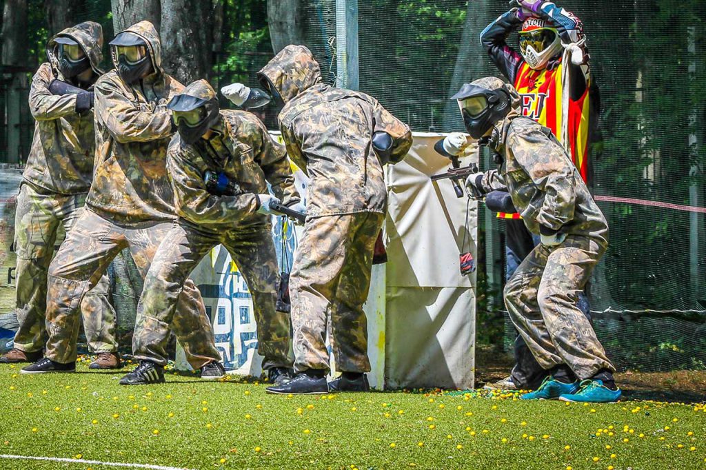 the paintball team is getting ready to fight on an artificial lawn