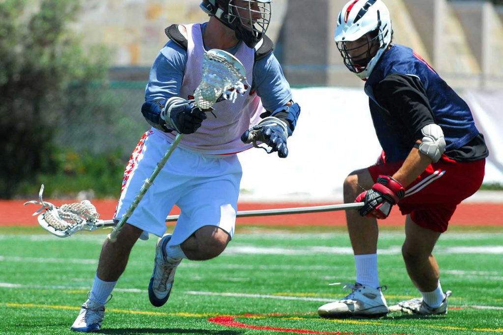 two players on the field playing lacrosse